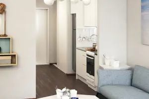 Vardagsrum med mörkt trägolv och vita väggar med tavlor på | Nivika Fastigheter AB (publ)