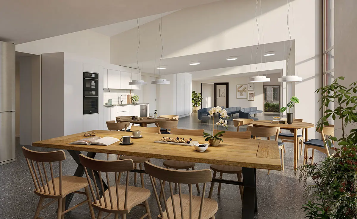 Vit kök med ett matsalsbord av trä i förgrunden | Nivika Fastigheter AB (publ)